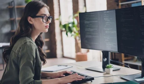 woman looking at screens used in a blog about steps to take in a cyber attack response plan