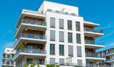 low rise apartment building with blue sky used on a blog about strata insurance