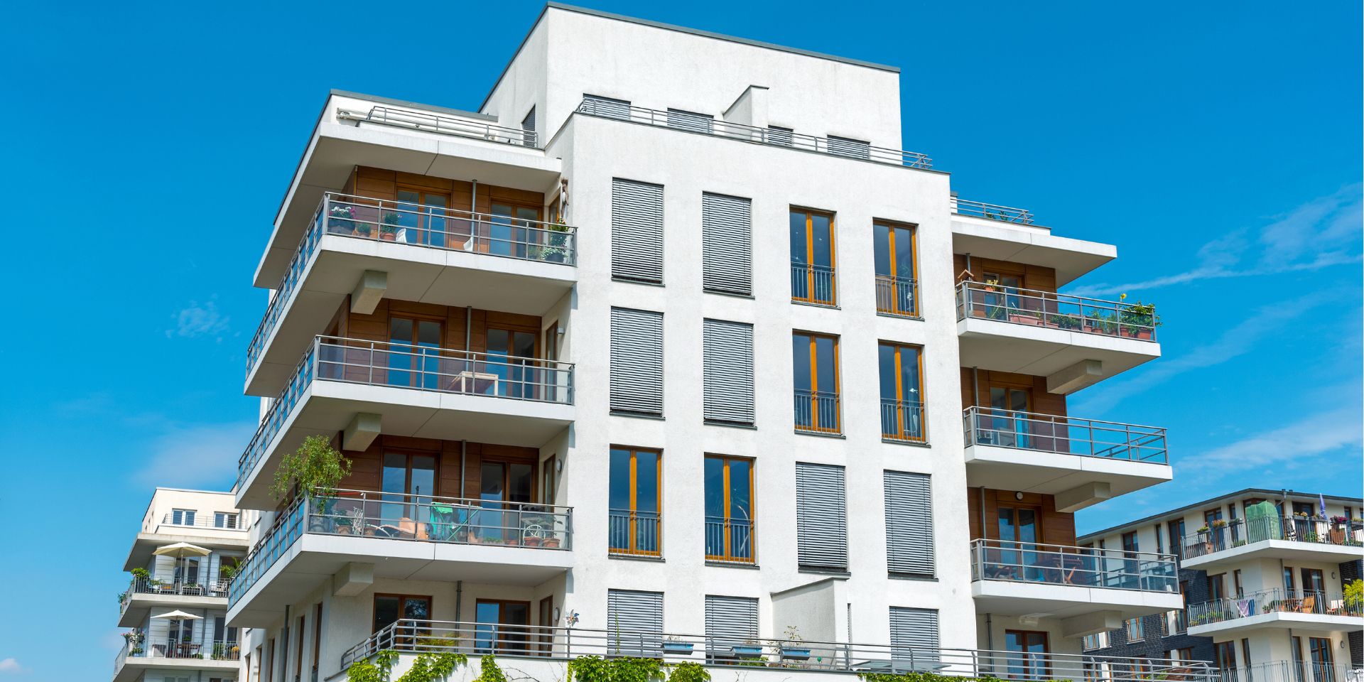 low rise apartment building with blue sky used on a blog about strata insurance