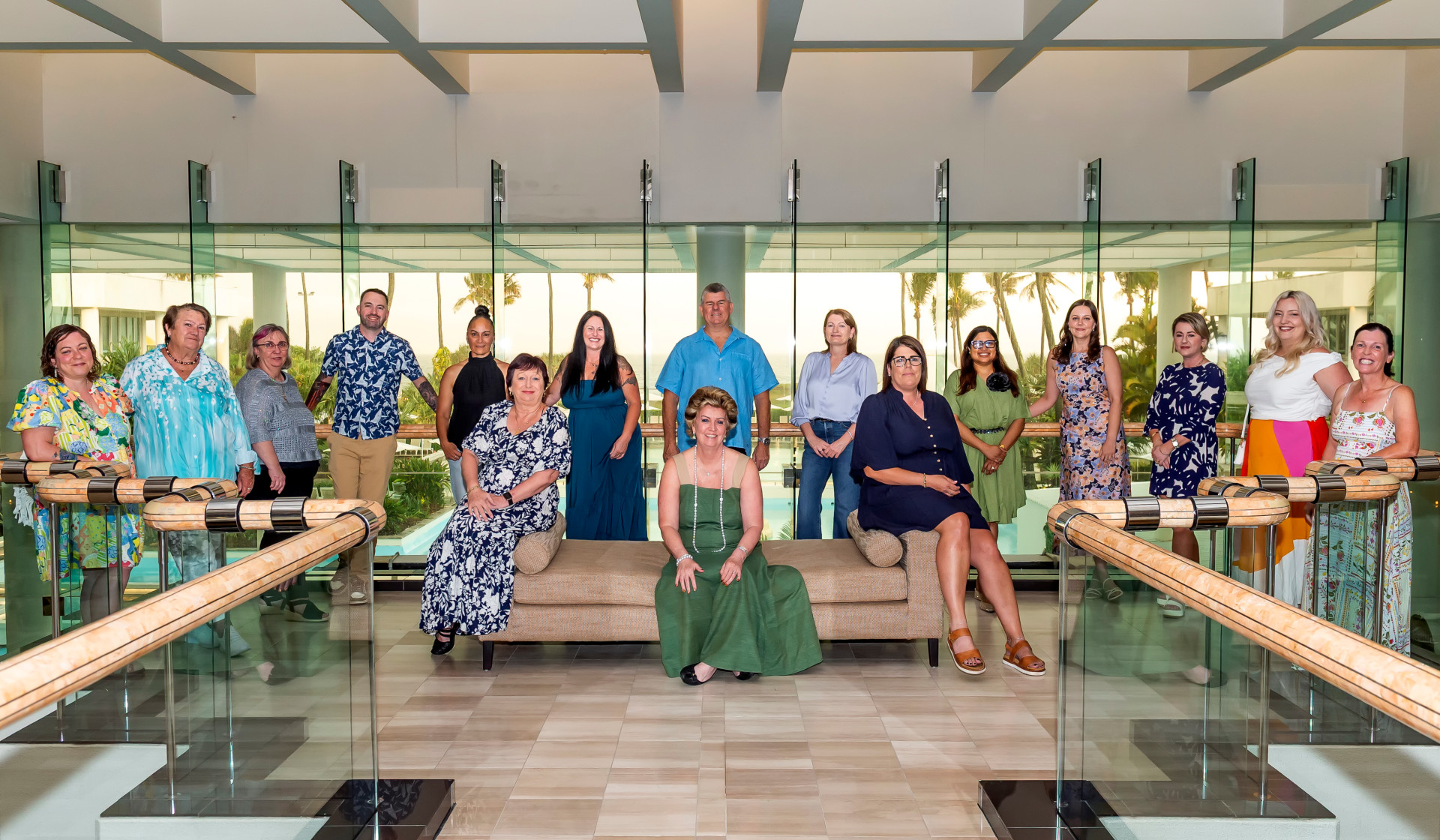 AIB Insurance team with senior members sat on a sofa and the team behind